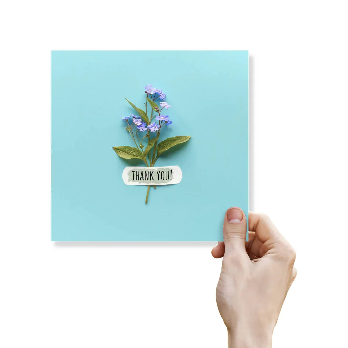 Blue thank you card with delicate purple flowers and a hand holding the greeting card