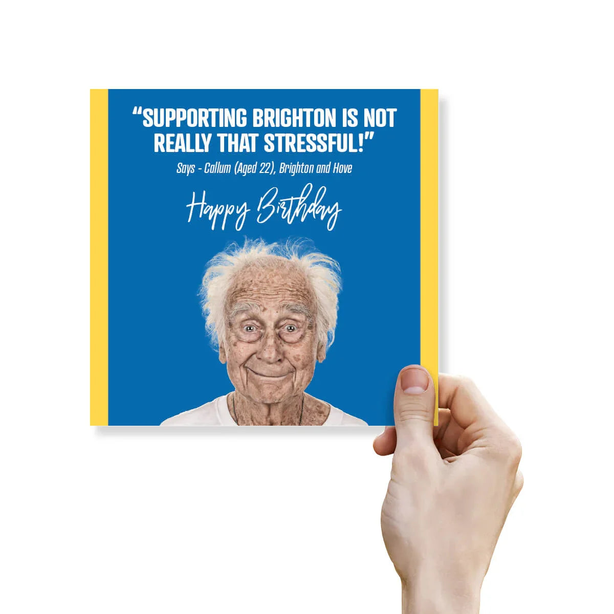 Hand holding a birthday card with an elderly man's face and humorous text on a blue background.