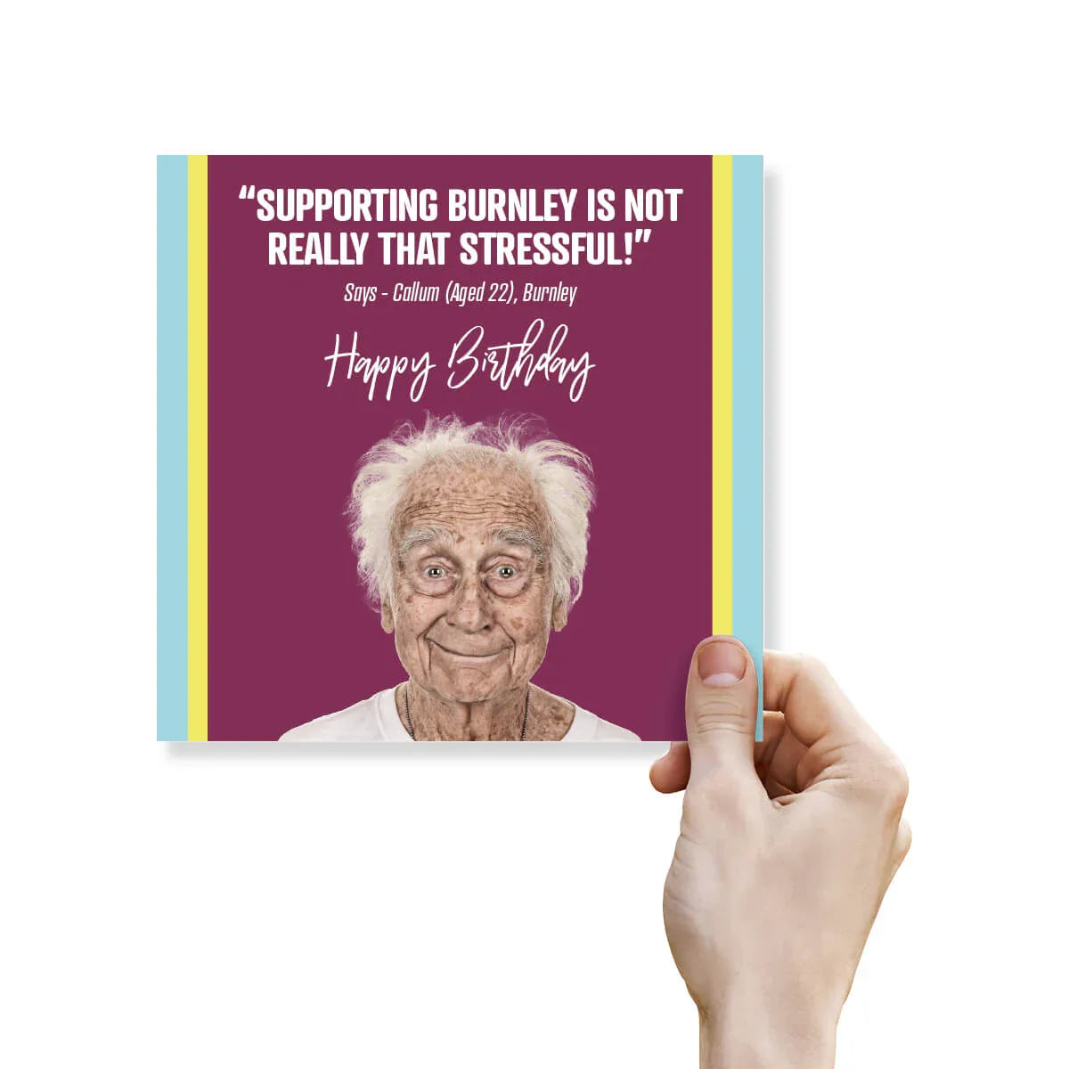 Hand holding a birthday card with an elderly man's face and humorous text on a purple background.