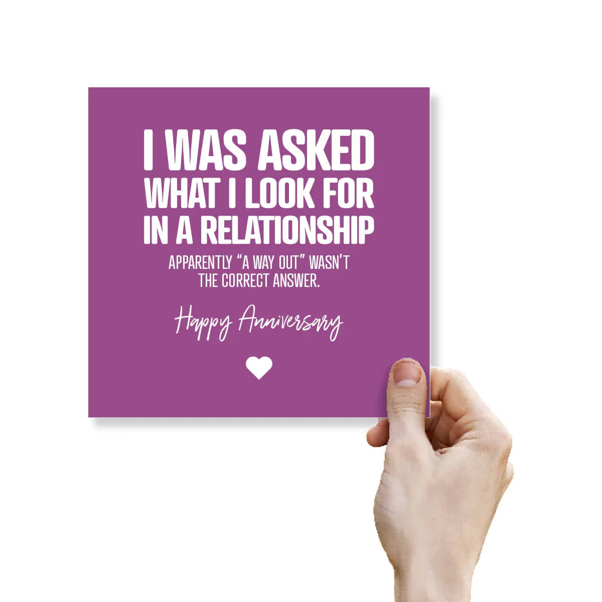 Purple card with white text and a heart symbol, held by a hand against a white background