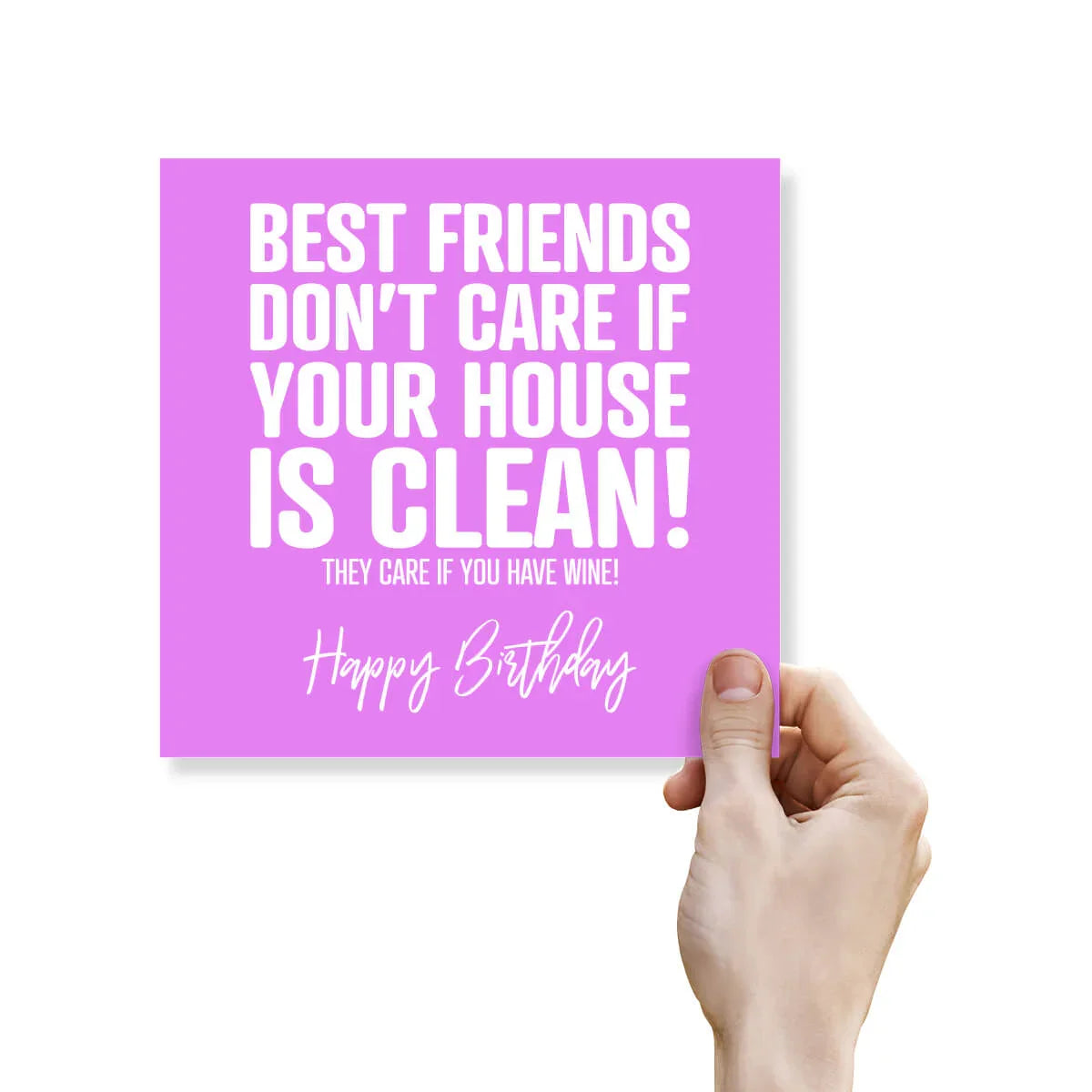 Hand holding a purple card with humorous birthday message on a white background