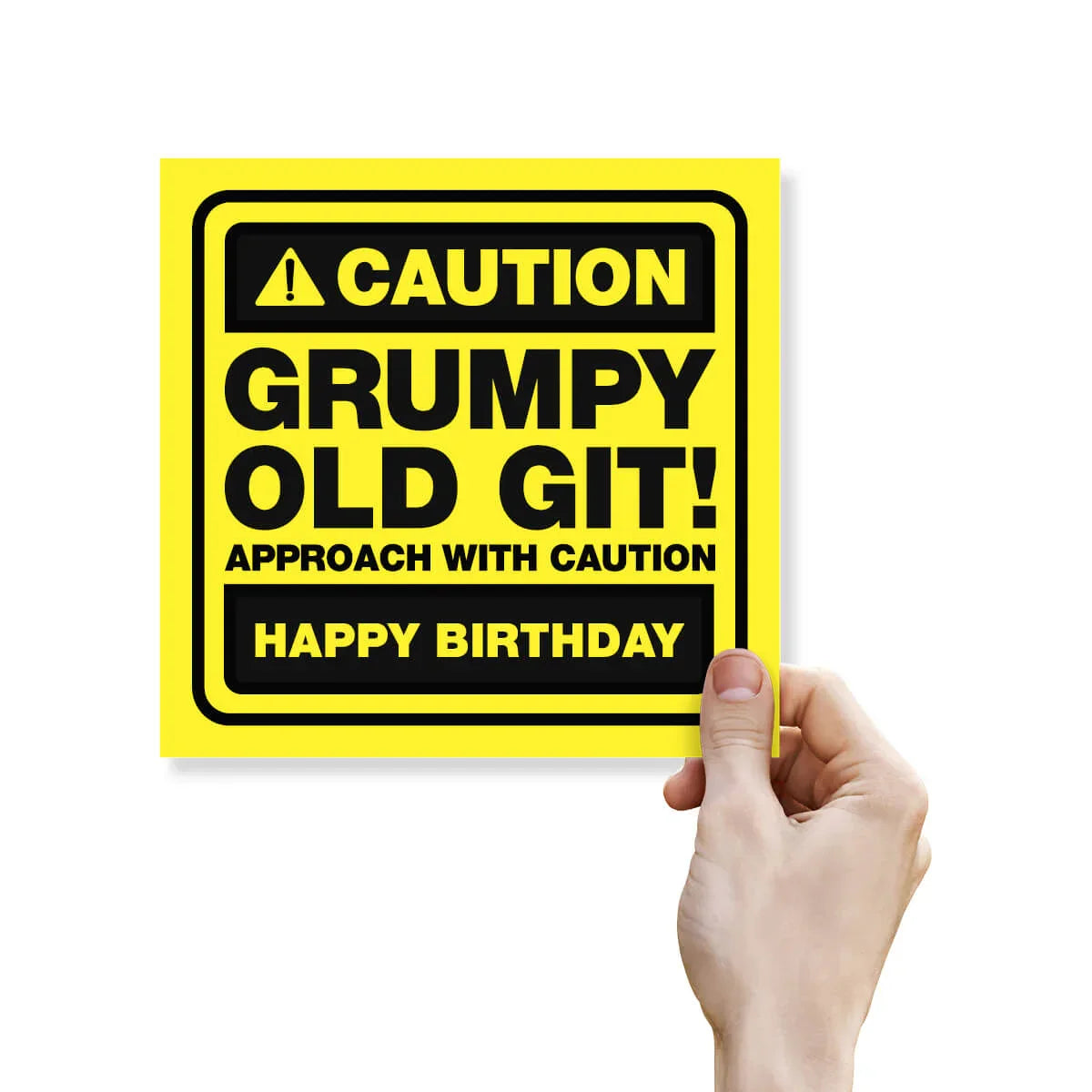 Hand holding a yellow sign with black text on a white background
