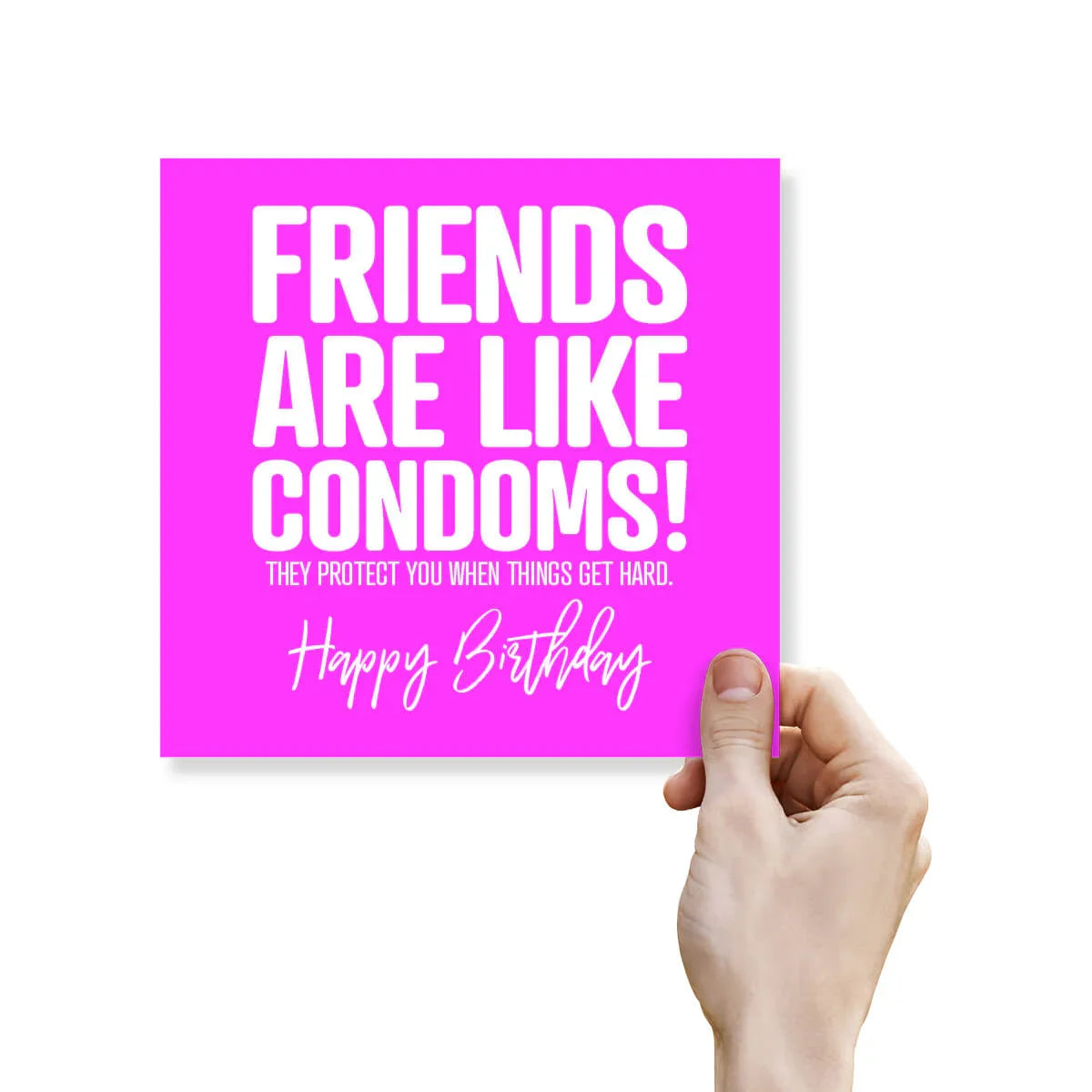 Hand holding a pink card with humorous birthday message on a white background