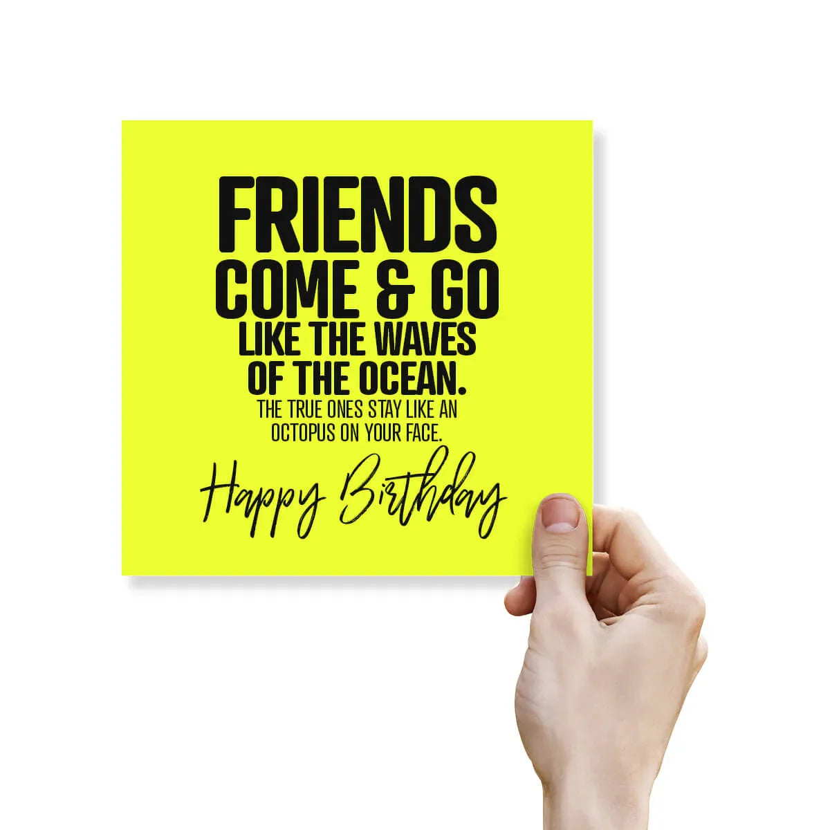 Hand holding a yellow card with a birthday message on a white background