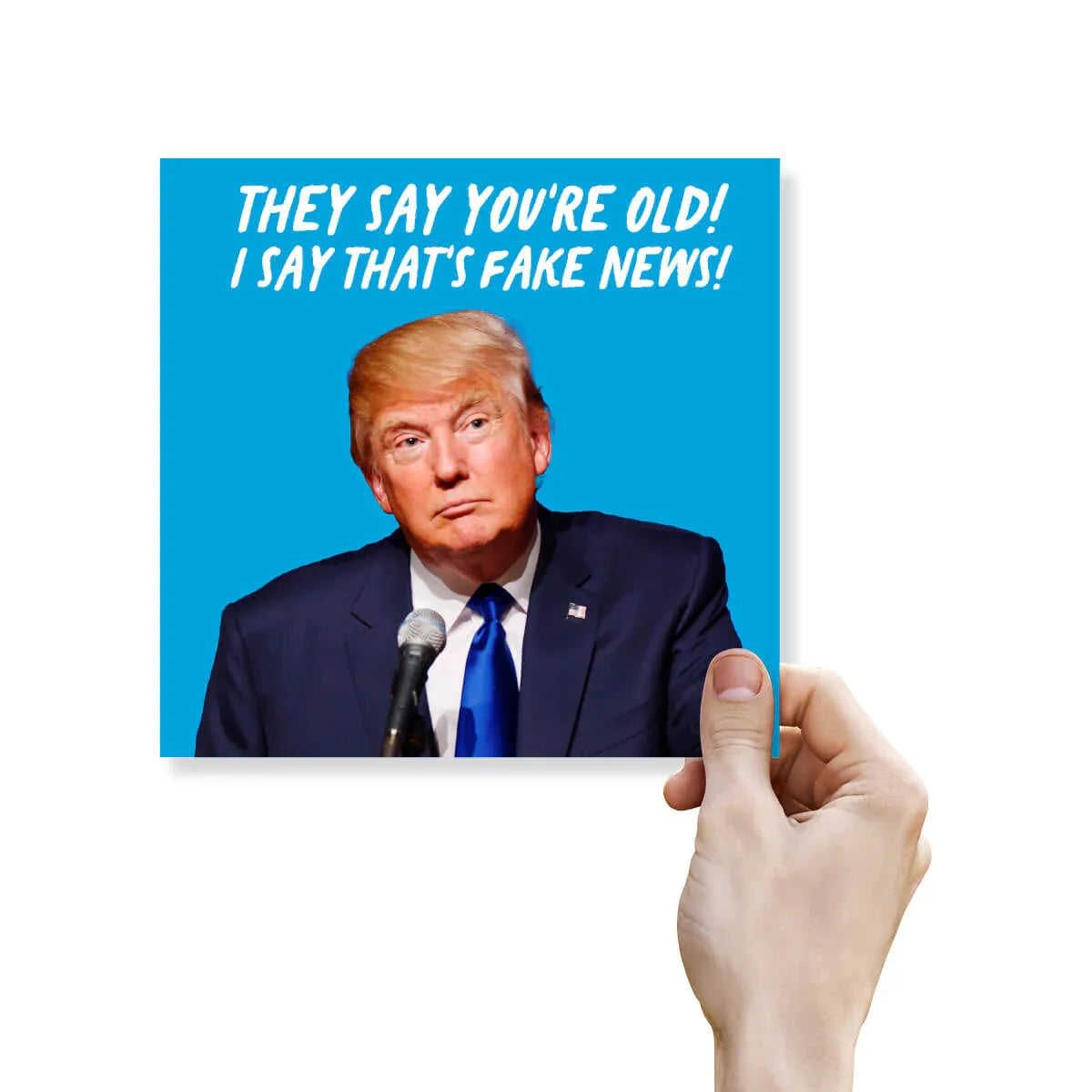 Hand holding a card with a picture of a politician and text on a blue background