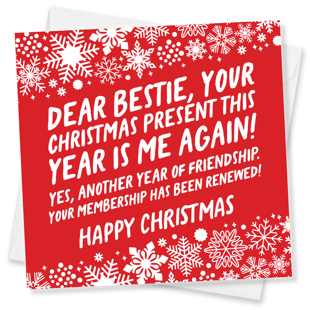 A red Christmas greeting card with white snowflake borders and bold white text that reads, 'DEAR BESTIE, YOUR CHRISTMAS PRESENT THIS YEAR IS ME AGAIN! YES, ANOTHER YEAR OF FRIENDSHIP! YOUR MEMBERSHIP HAS BEEN RENEWED! HAPPY CHRISTMAS.' A white envelope is partially visible behind the card on a white background.