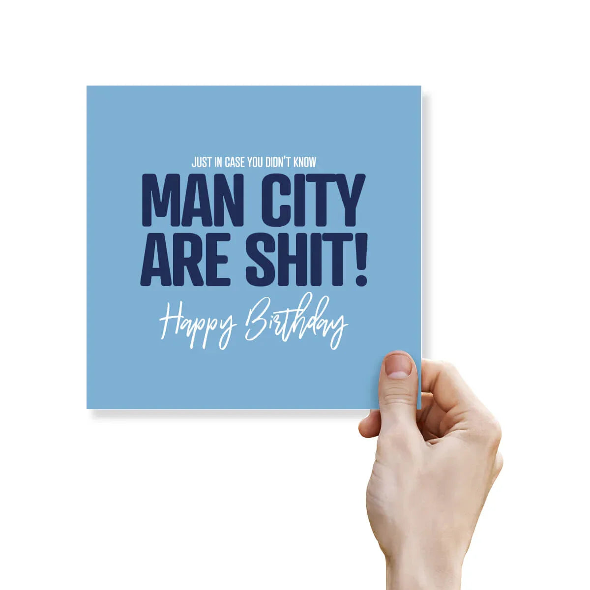 Rude funny Manchester City birthday card with bold blue text held by a hand on white background.