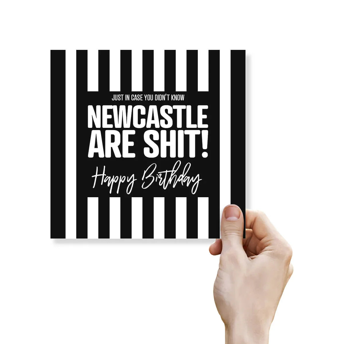 Funny rude Newcastle United birthday card with bold black and white striped design held by hand