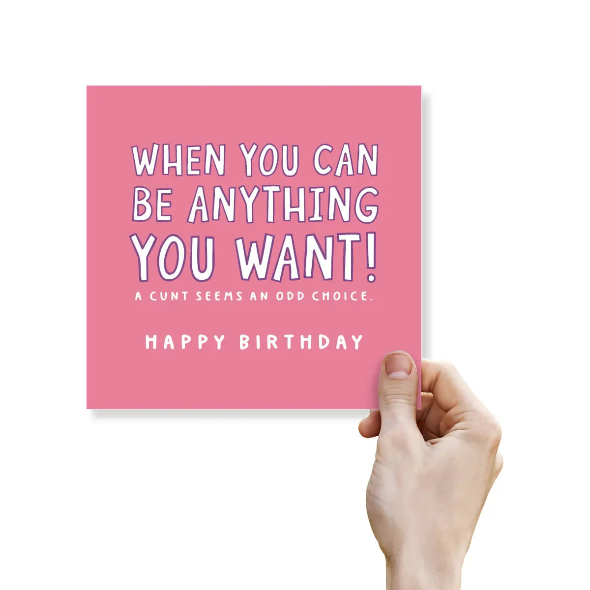 Pink birthday card with humorous text held by a hand on a white background