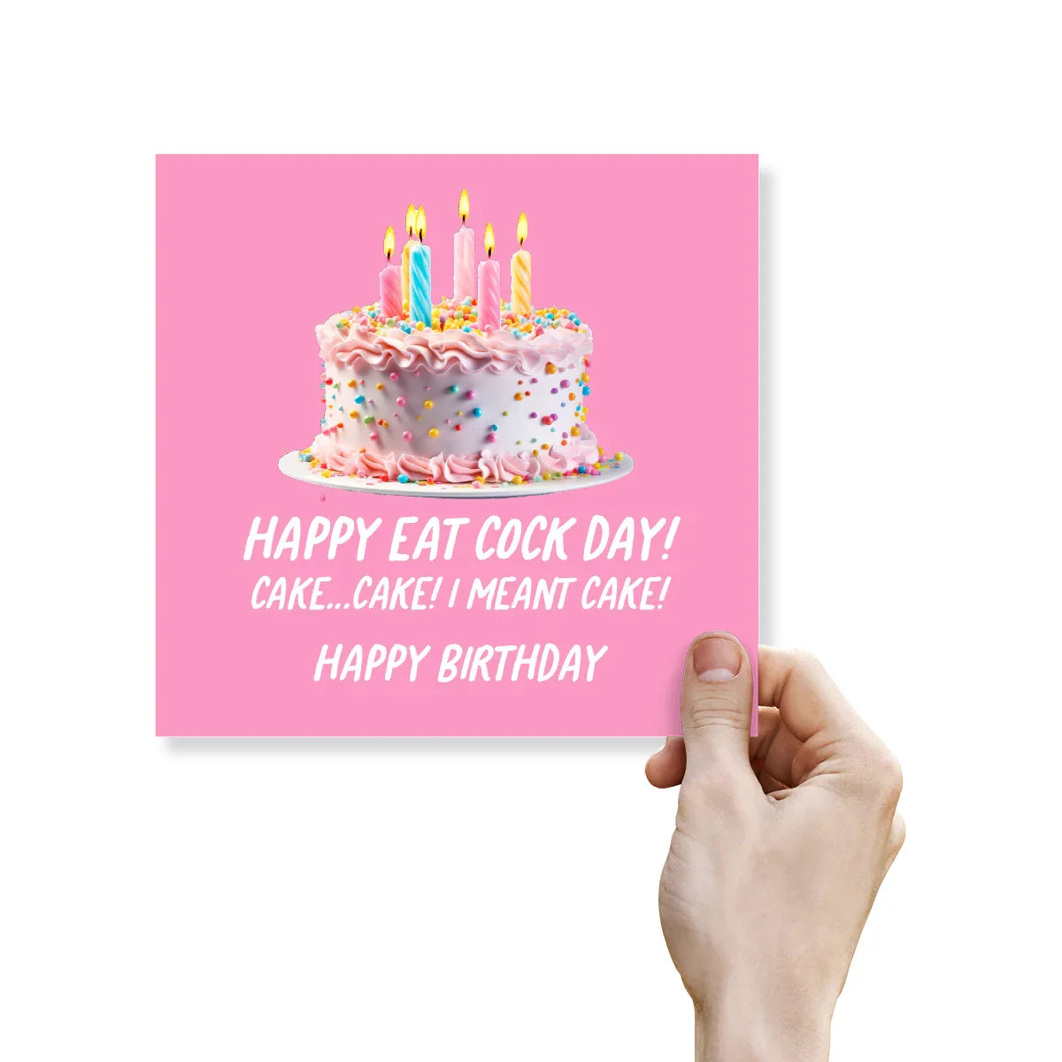 Hand holding a birthday card with a cake illustration and humorous text on a pink background