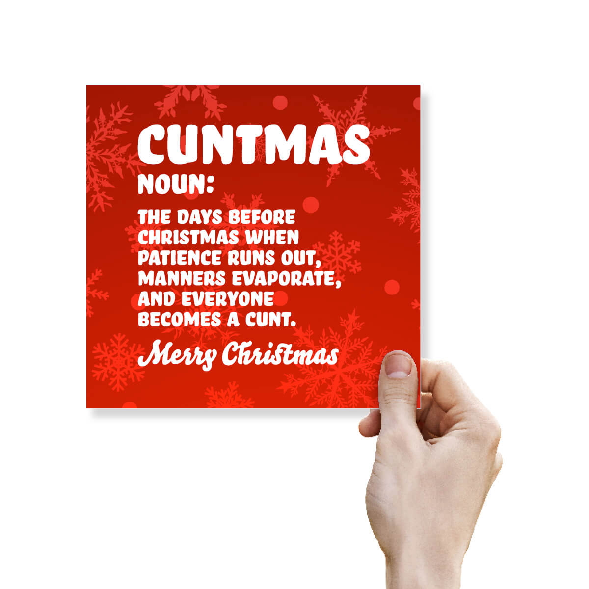 A hand holding a square red Christmas greeting card with white text that reads 'CUNTMAS NOUN: THE DAYS BEFORE CHRISTMAS WHEN PATIENCE RUNS OUT, MANNERS EVAPORATE, AND EVERYONE BECOMES A CUNTMAS. Merry Christmas.