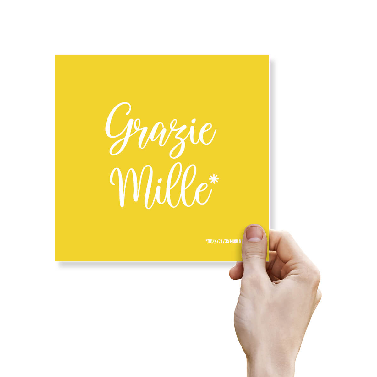 Hand holding a yellow card with 'Grazie Mille' text on a white background
